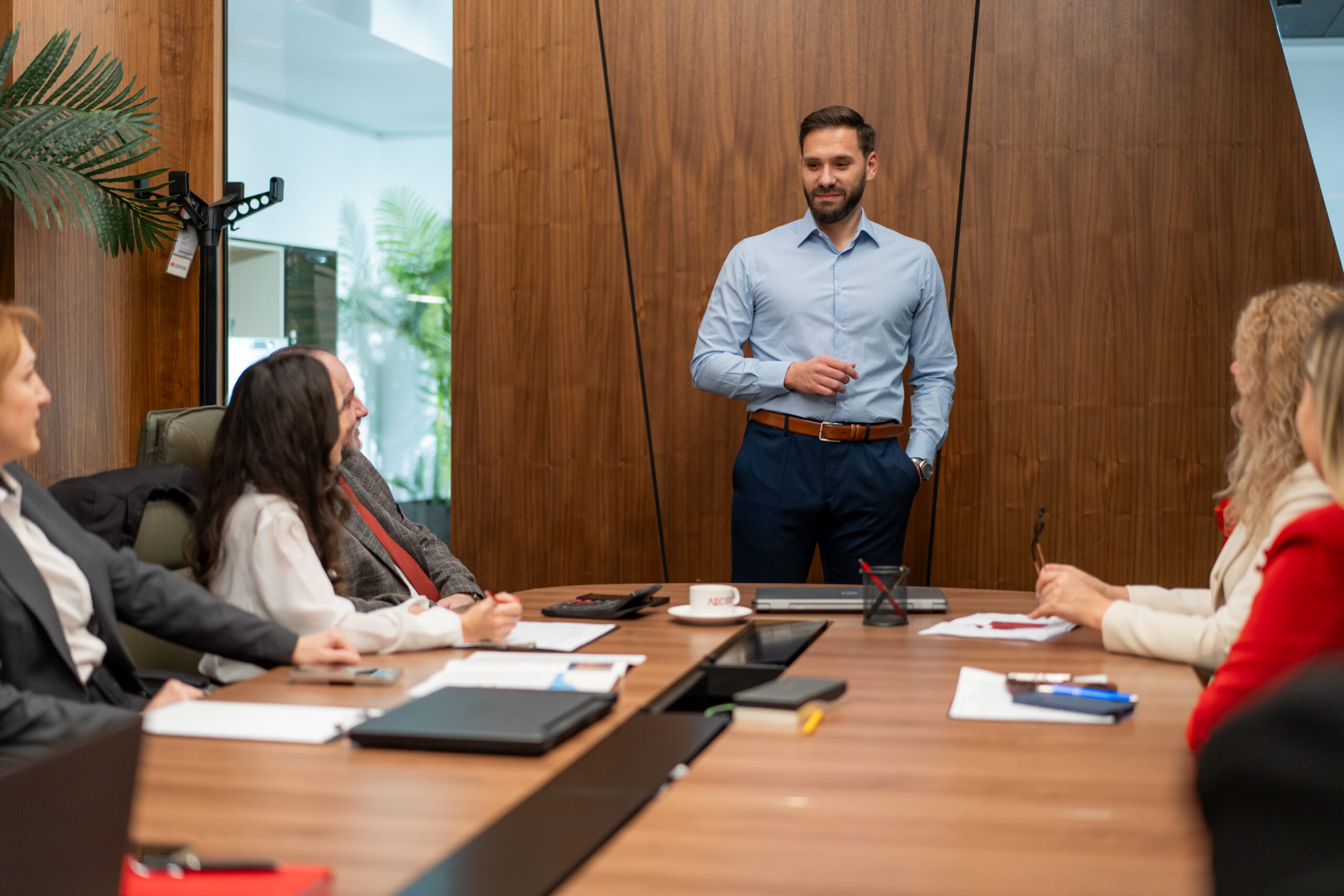 Mihnea Zamfirescu leading a business meeting with his team, discussing strategic legal and accounting solutions.