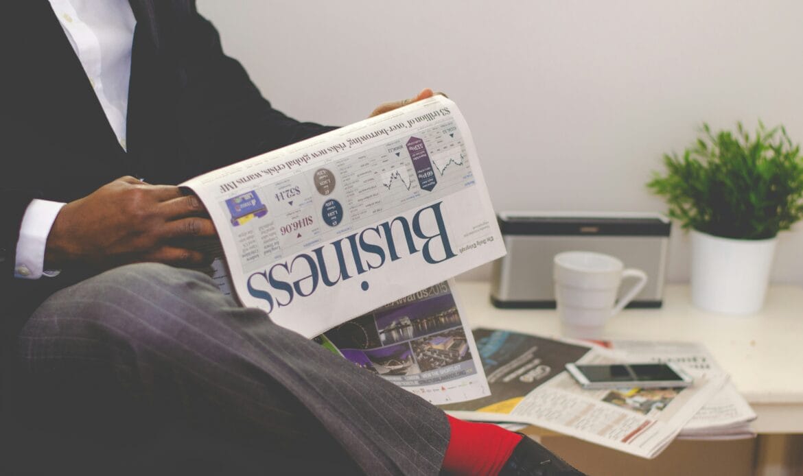 Business professional reviewing financial news, representing Romania’s legal and economic landscape.