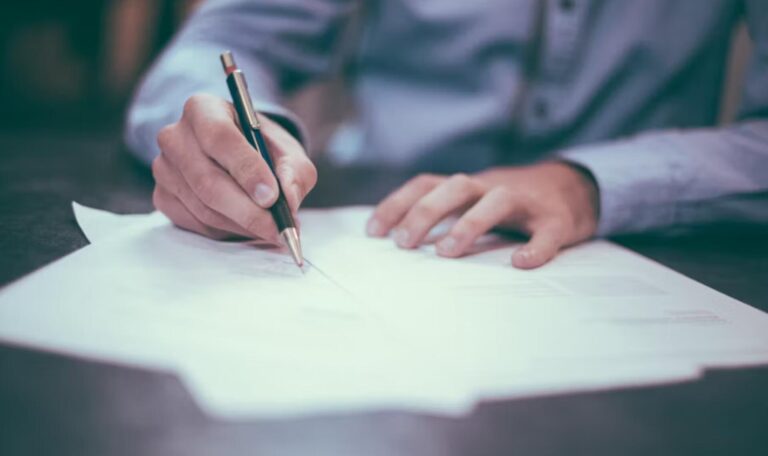 Business professional signing a commercial contract for legal compliance and business security.