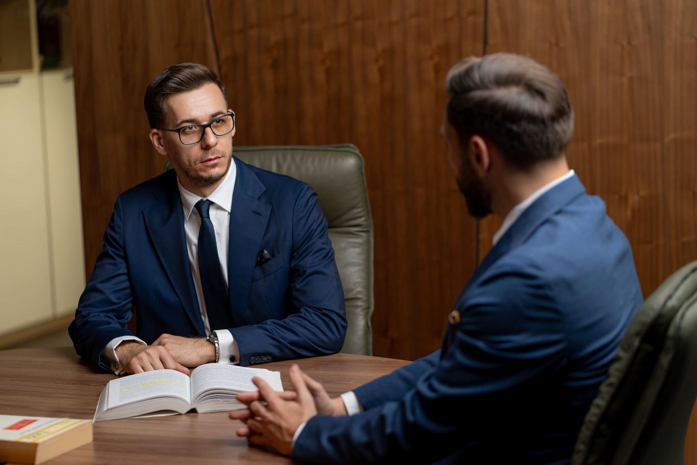 Laurențiu and Mihnea in a focused legal consultation, discussing corporate legal strategies at LegalHunt.