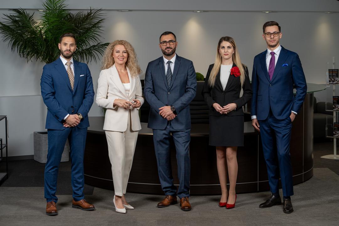 The LegalHunt leadership team and employees in a professional office setting, featuring Mihnea Zamfirescu on the left, Laurențiu Asaftei on the right, and the accountancy partner in the center.