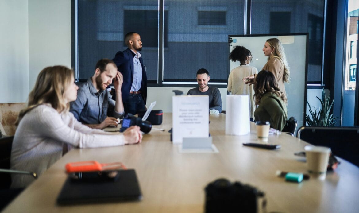 Startup team discussing funding strategy in a modern workspace.