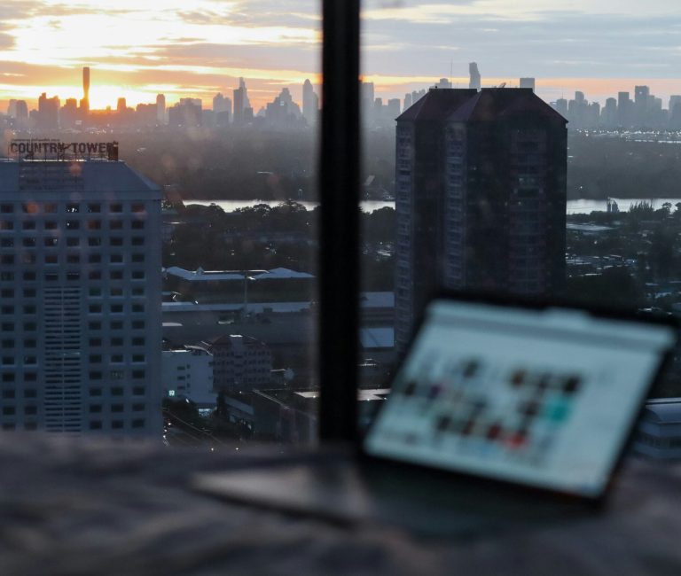 Digital nomad working remotely in Romania with a cityscape view.