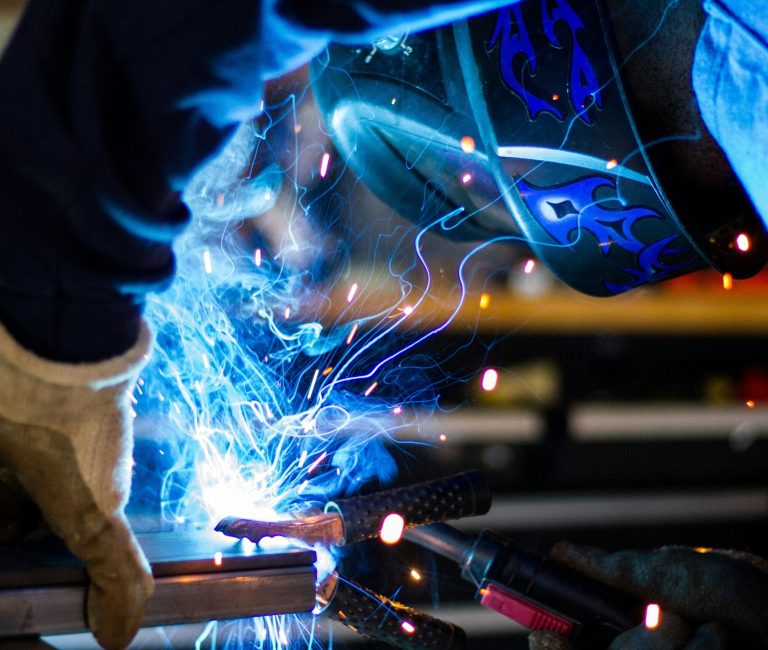 Welder in protective gear, representing Romania’s industrial growth and manufacturing economy.