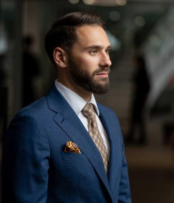 Mihnea Zamfirescu – Visionary Legal Expert and Co-Founder Professional portrait of Mihnea Zamfirescu, founding partner of Legalhunt, wearing a tailored blue suit and looking confidently ahead.