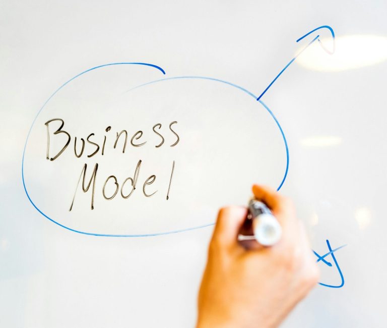 Entrepreneur sketching a business plan on a whiteboard for a startup in Romania.
